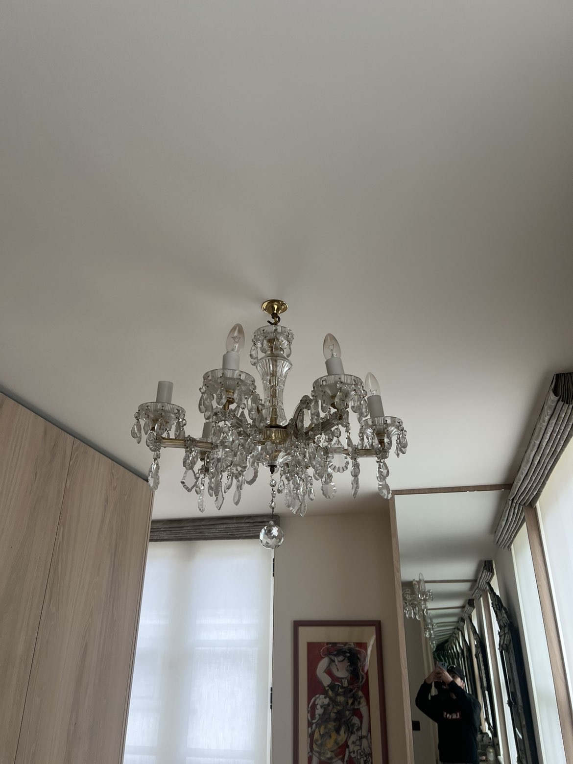 Crystal chandelier installed on a bedroom ceiling