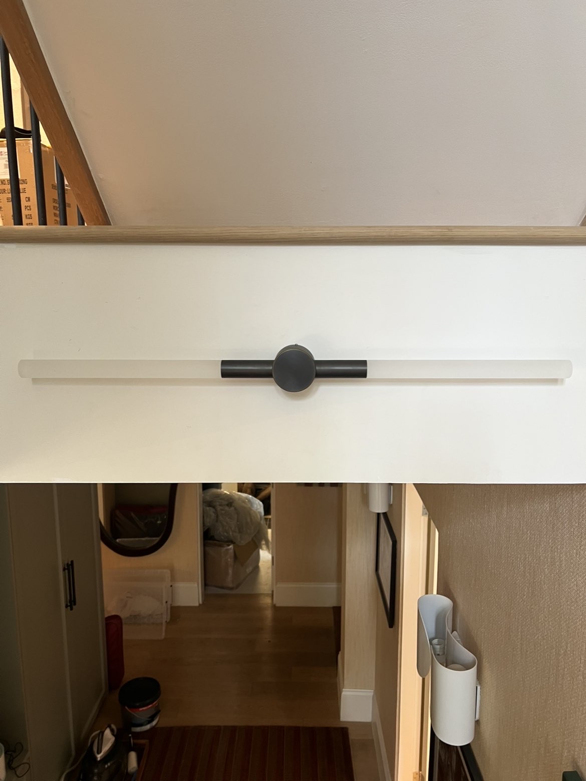 Long linear wall light fitted centrally on a stairwell wall
