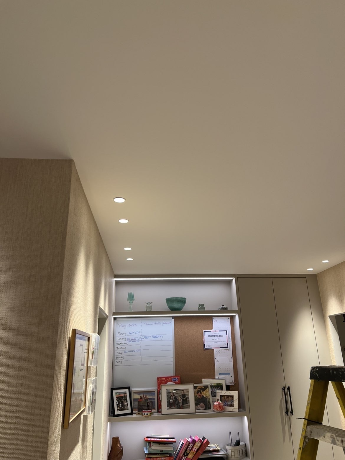 Recessed downlights and LED strip lighting above fitted shelving